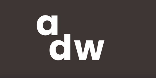 White logo of Antwerp Design Week on a dark background