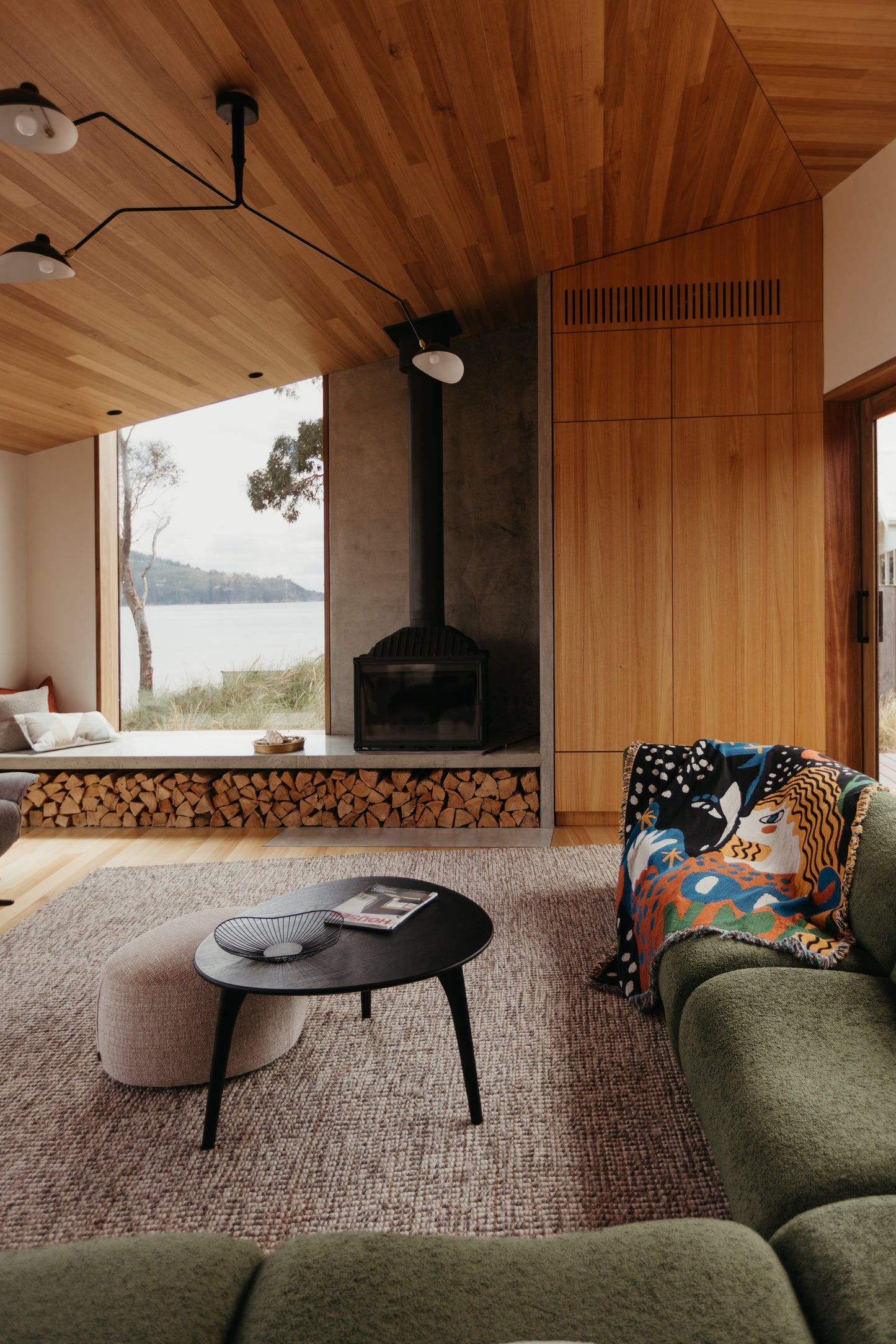 Alma woven blanket by Enikő Katalin Eged for Slowdown studio styled in warm modern interior, adding sculptural color and artistic presence