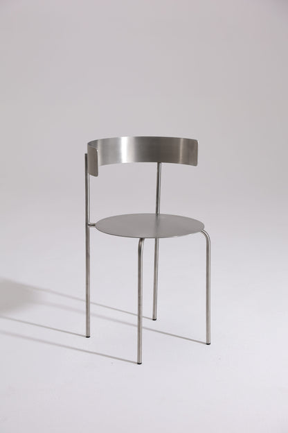 MEADOW chair in brushed stainless steel with curved backrest, minimalist design by The Good Living & Co.