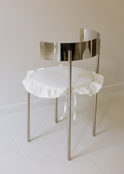 MEADOW chair with white ruffled cushion and reflective steel frame, made to order by The Good Living & Co.