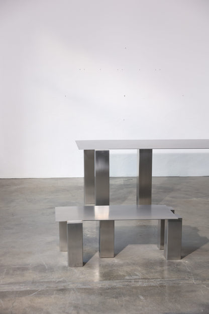 TRIUM coffee table in brushed stainless steel with structured rectangular legs, studio view, by The Good Living & Co