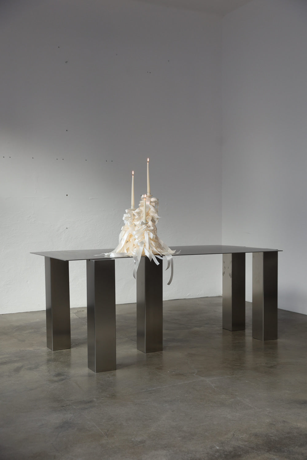 ATRIUM desk in brushed steel with bold rectangular legs, styled with white candles, by The Good Living & co
