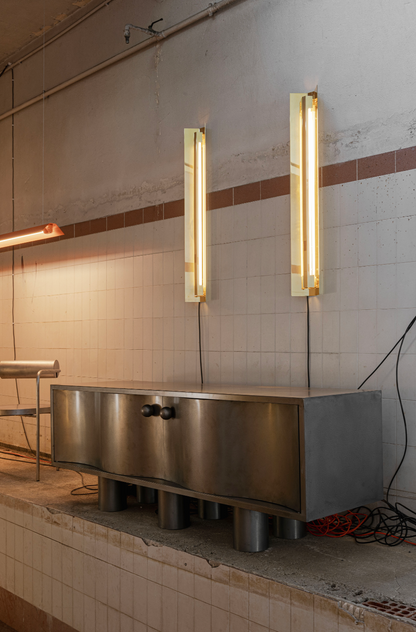 MOTION steel commode styled in an interior space alongside tall floor lamps, The Good Living & Co.