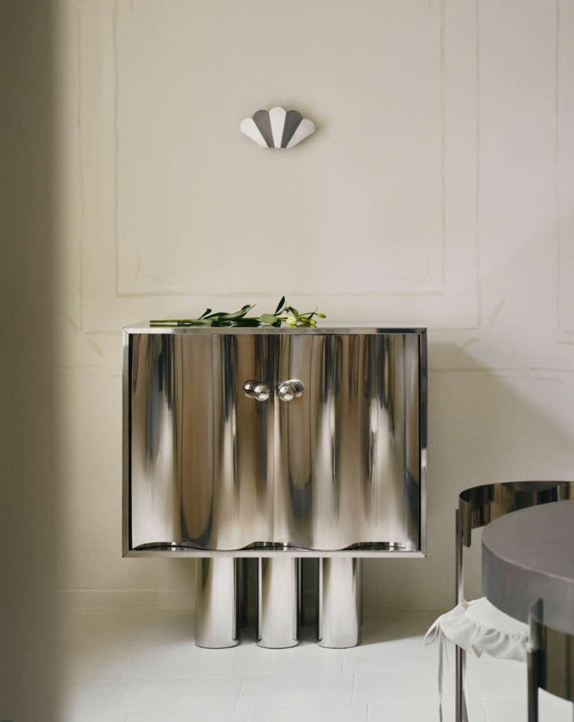 MOTION polished stainless steel commode with sculptural wave-front doors, side angle view, by The Good Living & Co.