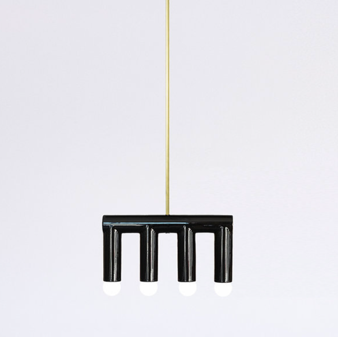 Handmade contemporary hanging lamp by Pani Jurek — black ceramic structure with brass details, featuring sculptural geometric forms suspended from a single point.