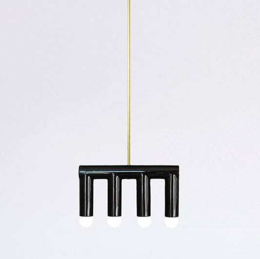 Handmade contemporary hanging lamp by Pani Jurek — black ceramic structure with brass details, featuring sculptural geometric forms suspended from a single point.