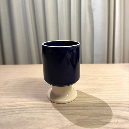 Ceramic designermug by Malwina Konopacka in ecru and cobalt, a playful sculptural cup with a goblet-like stem, part of the curated RUIMTE collection
