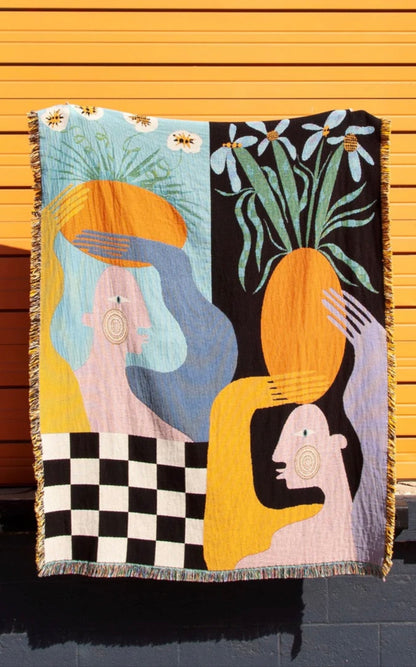 Moretti woven throw blanket by Imogen Sinclair displayed as textile wall art against a coloured wall