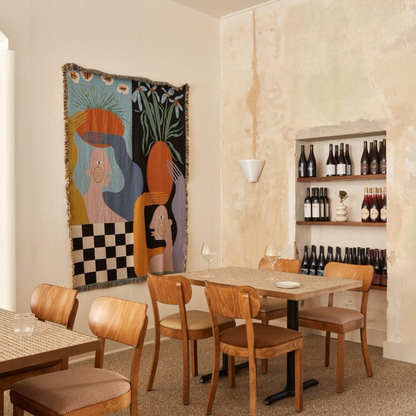 Moretti woven throw blanket by Imogen Sinclair hanging as textile wall art in a dining area