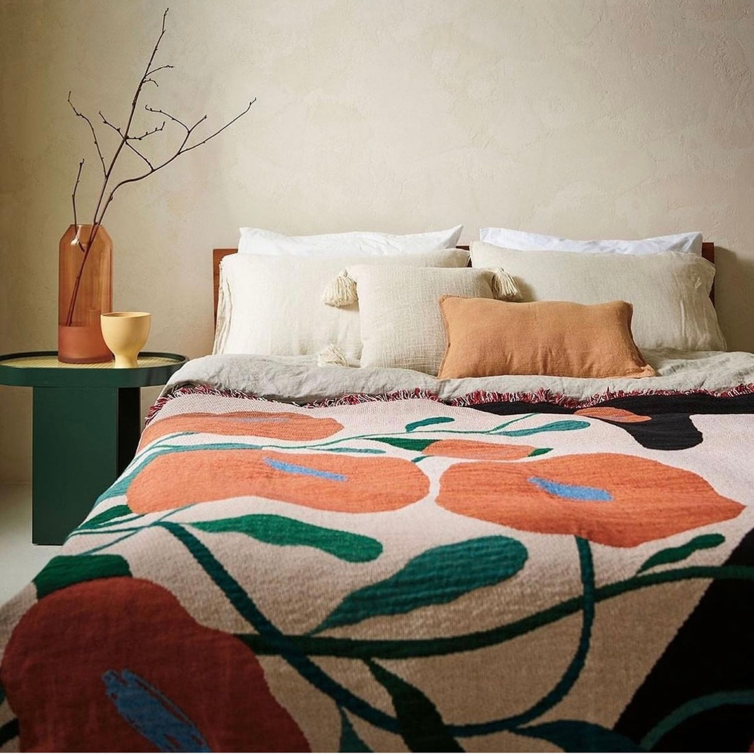 Melba woven throw blanket by Suvi Suitiala styled on a bed as a functional art textile